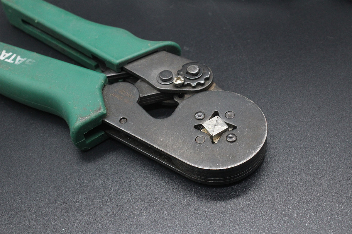 Dirty metal pliers covered with surface grime before laser cleaning comparison.