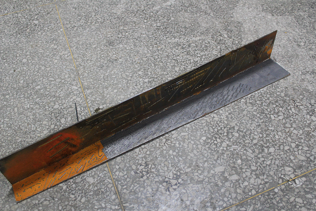 Laser cleaning removes rust and oxidation from an L-shaped steel piece, showing a clear transition between treated and untreated metal.