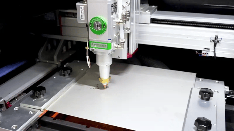 Fiber laser cutting machine processing a metal sheet, producing smooth, burr-free edges with high-precision beam control.