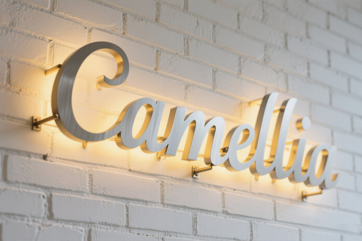 Backlit metal “Camellia” sign welded with precision laser spot welding for lighting decor.