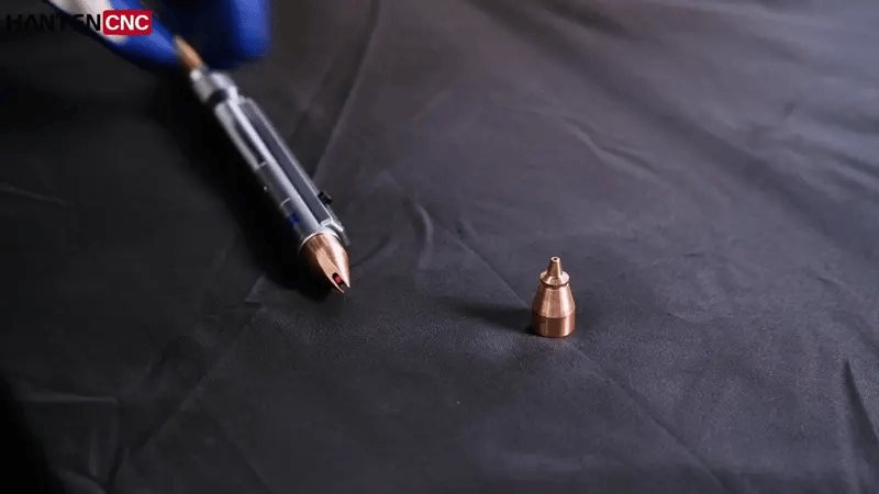 Laser spot welding micro-metal parts with a precision QCW welding head, producing clean sparks and accurate welds.