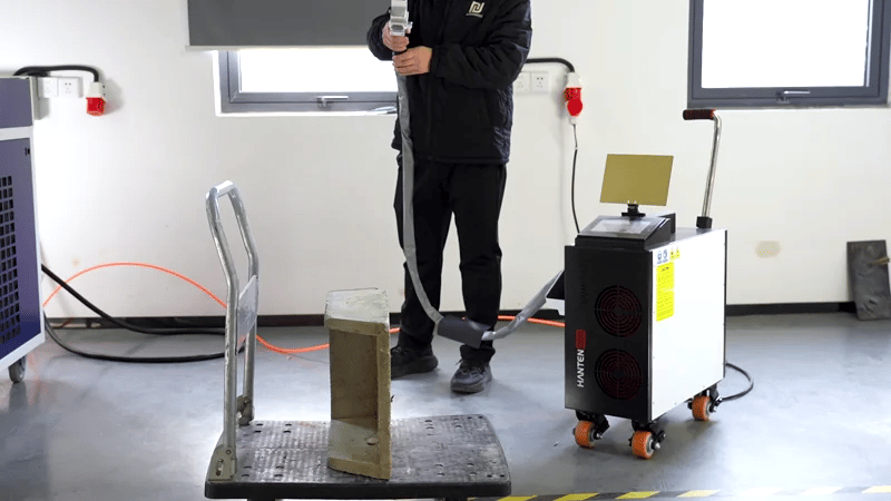 Continuous-wave laser stone cleaner removing dirt and buildup from a stone block with precise, non-contact laser cleaning.