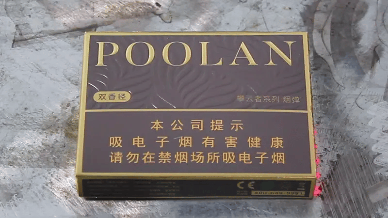 Laser paint removal machine stripping paint and ink from paperboard surface with precise, low-heat laser beam.