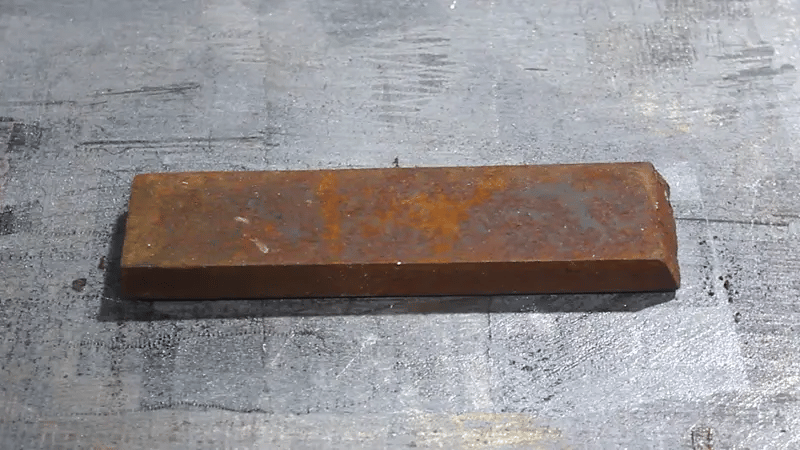 Laser rust cleaning machine removing rust from metal surface using high-precision fiber laser beam.