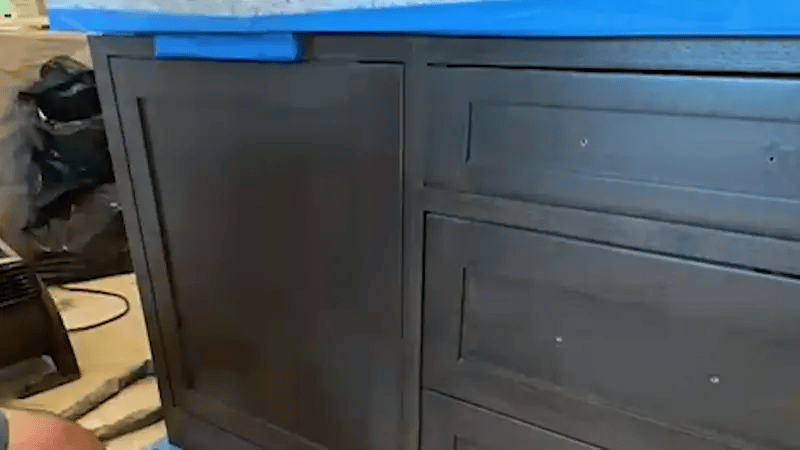 Pulse laser cleaning machine restoring wooden furniture by removing varnish and stains while preserving natural wood grain.